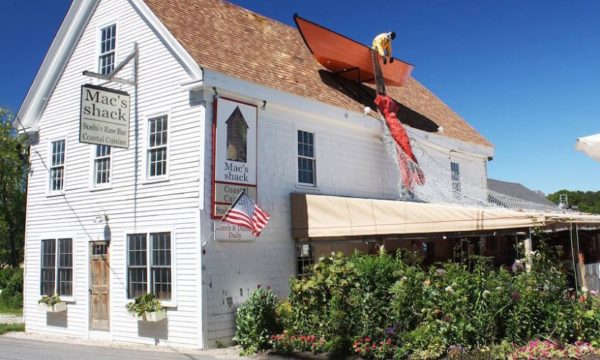 macs-shack-wellfleet-white-painted-clapboard-inn-with-garden-and-boat-on-roof-2022