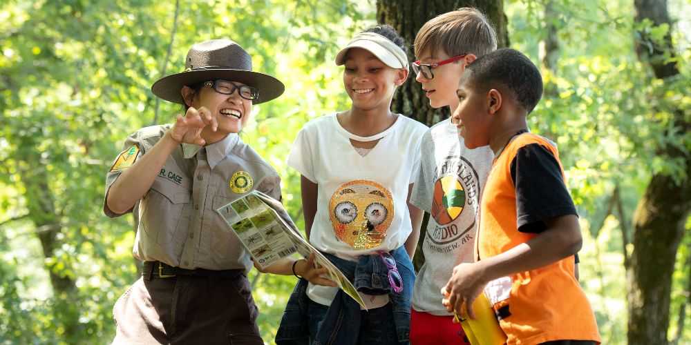 ranger-playing-in-sunny-forest-with-teenagers-cane-creak-state-park-arkansas