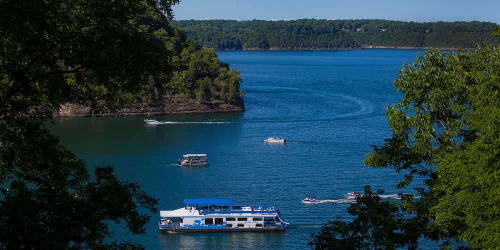 family-boating-on-lake-cumberland-during-summer-with-blue-skies-and-lush-trees