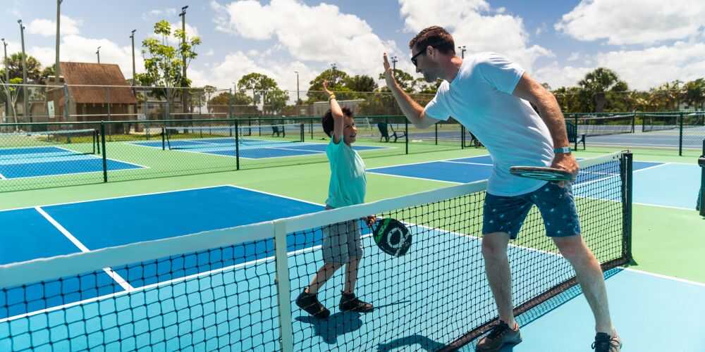 father and son pickleball game on Club Med family vacations in Florida