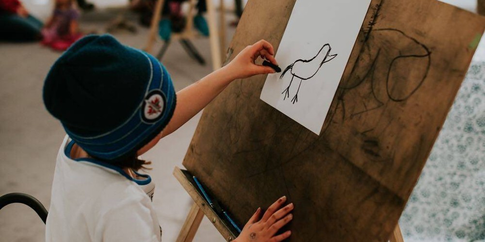 audain-art-museum-child-drawing-at-easel-craft-workshop-whistler-blackcomb-resort-canada