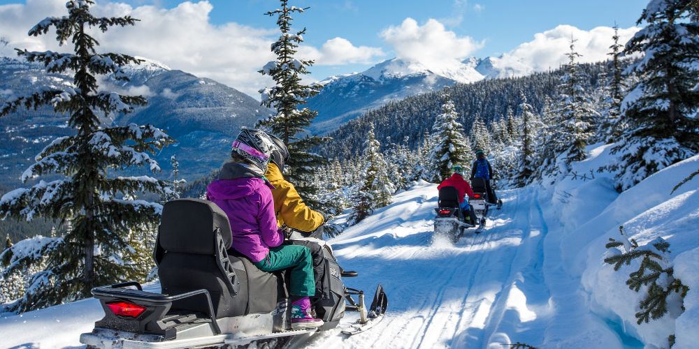 family-snowmobiling-canada-snowy-winter-forests-whistler-bucket-list