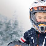 little-boy-snowmobile-helmet-snowy-winter-landscape-kid-friendly-whistler-canada
