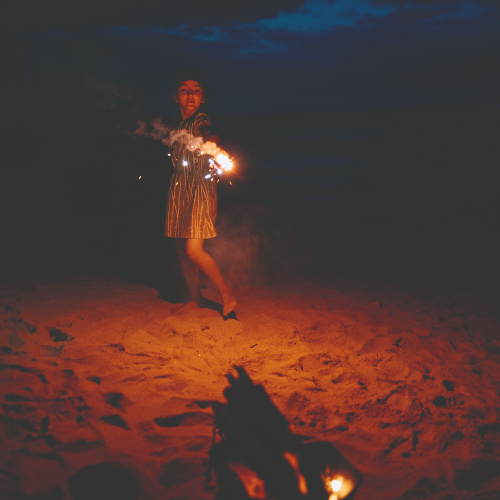 girl-playing-with-sparklers-on-beach-after-dark-on-floridas-panhandle-2022