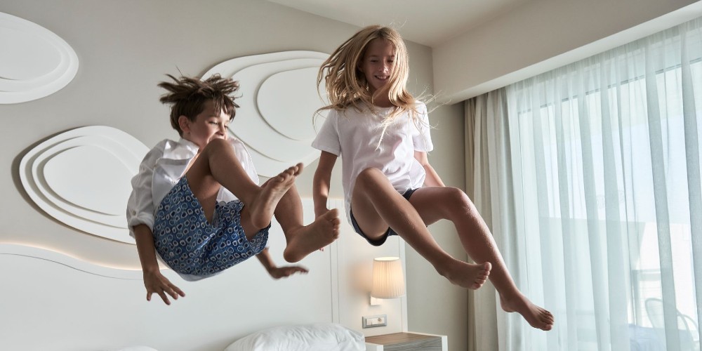 children-jumping-on-bed