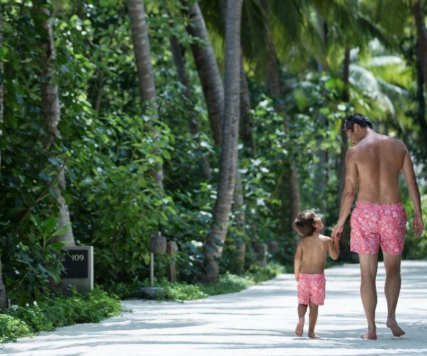 father-son-in-swim-shorts-walking-in-jungle-vakkaru-resort-2022