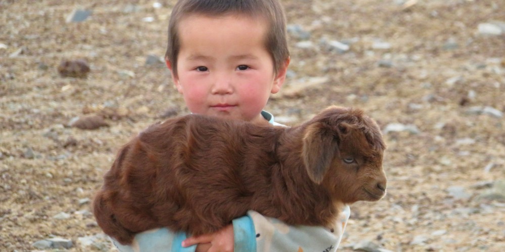 mongolian-child-with-baby-goat-tom-schuller