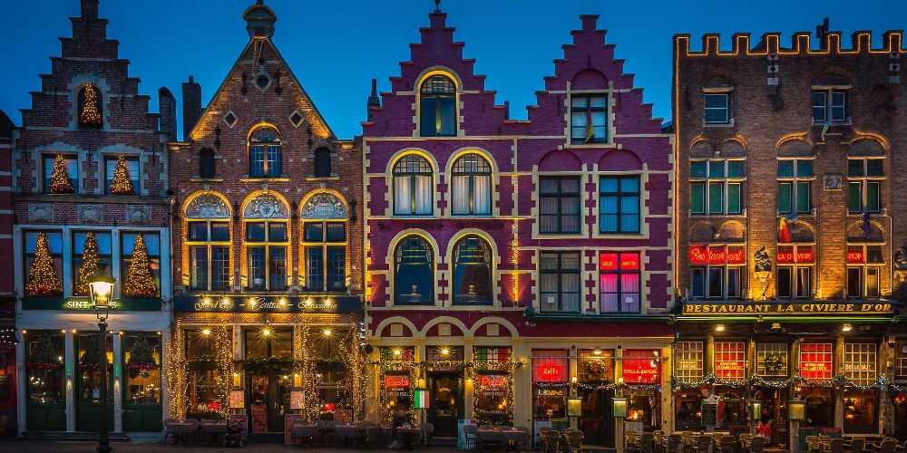 Bruges old town at Christmas with decorated shop fronts for family winter breaks with kids