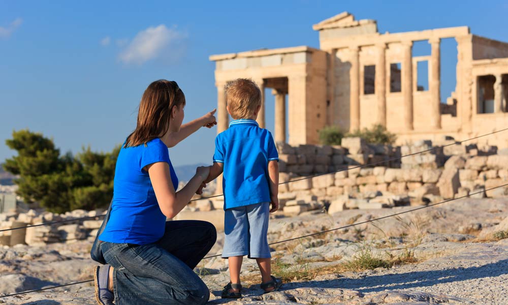 mother-and-son-looking-at-ancient-greek-temple-greece