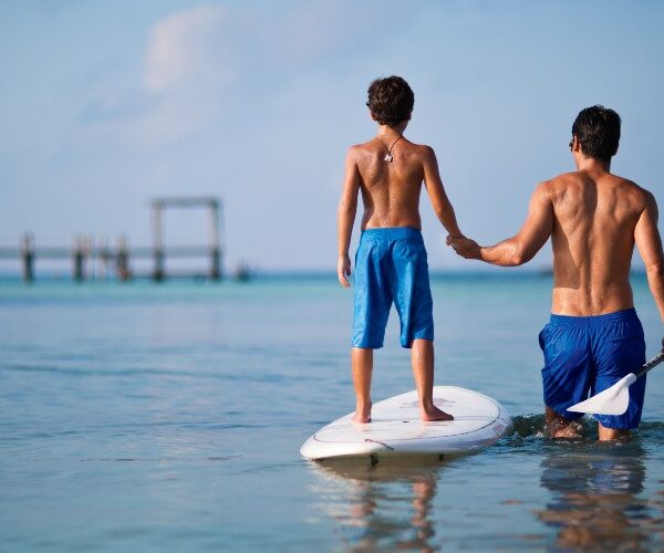 father-son-paddleboarding-NIZUC-resort-and-spa-cancun-2022