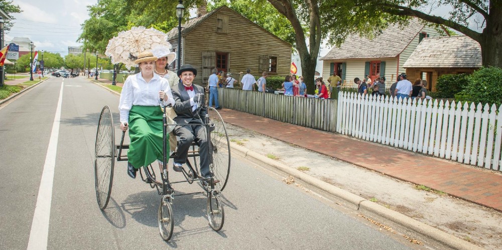 family-on-vintage-bike-dressed-in-victorian-costume-pensacola-historic-village-2022