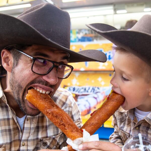 calgary-stampede-dad-and-son-eating-corndogs