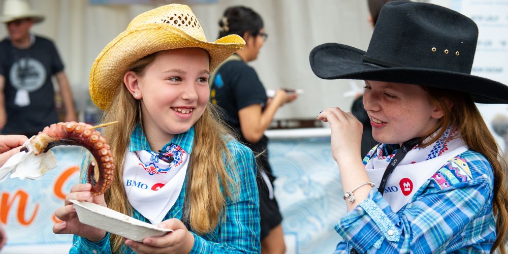 girls-in-cowboy-hats-eating-octopus-tentacles