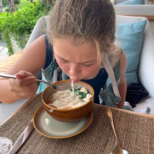 girl-eating-noodles-holiday-thailand